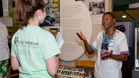 Community and School Events CDC Ambassador talking with museum guest.