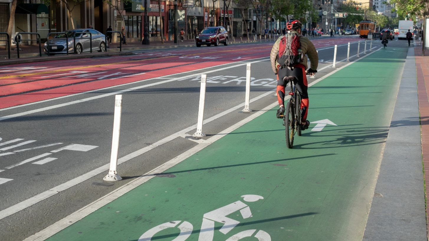 — title missing — Person bicycling in separated bike lane.