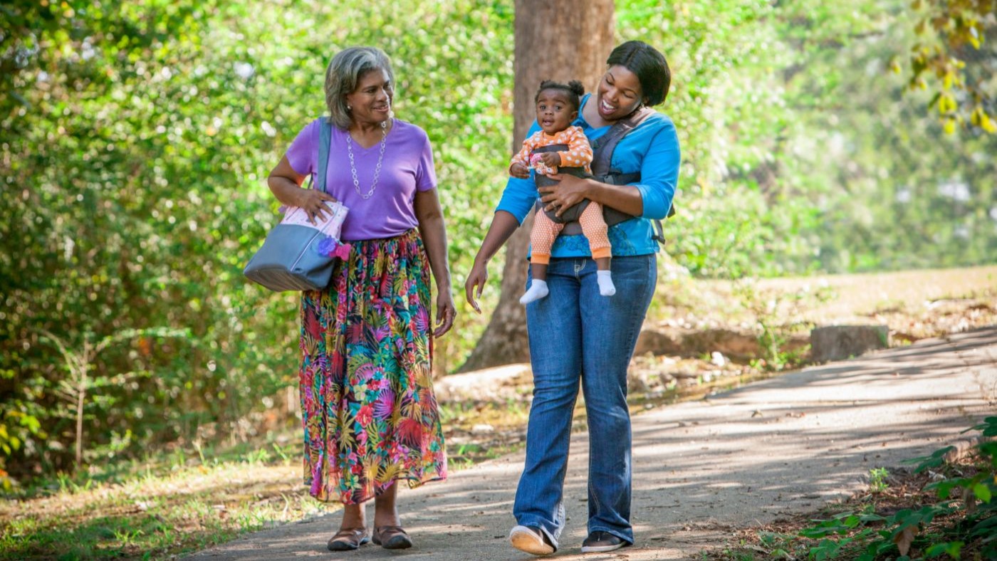 — title missing — Grandmother, mother, and daughter taking a walk in the park.
