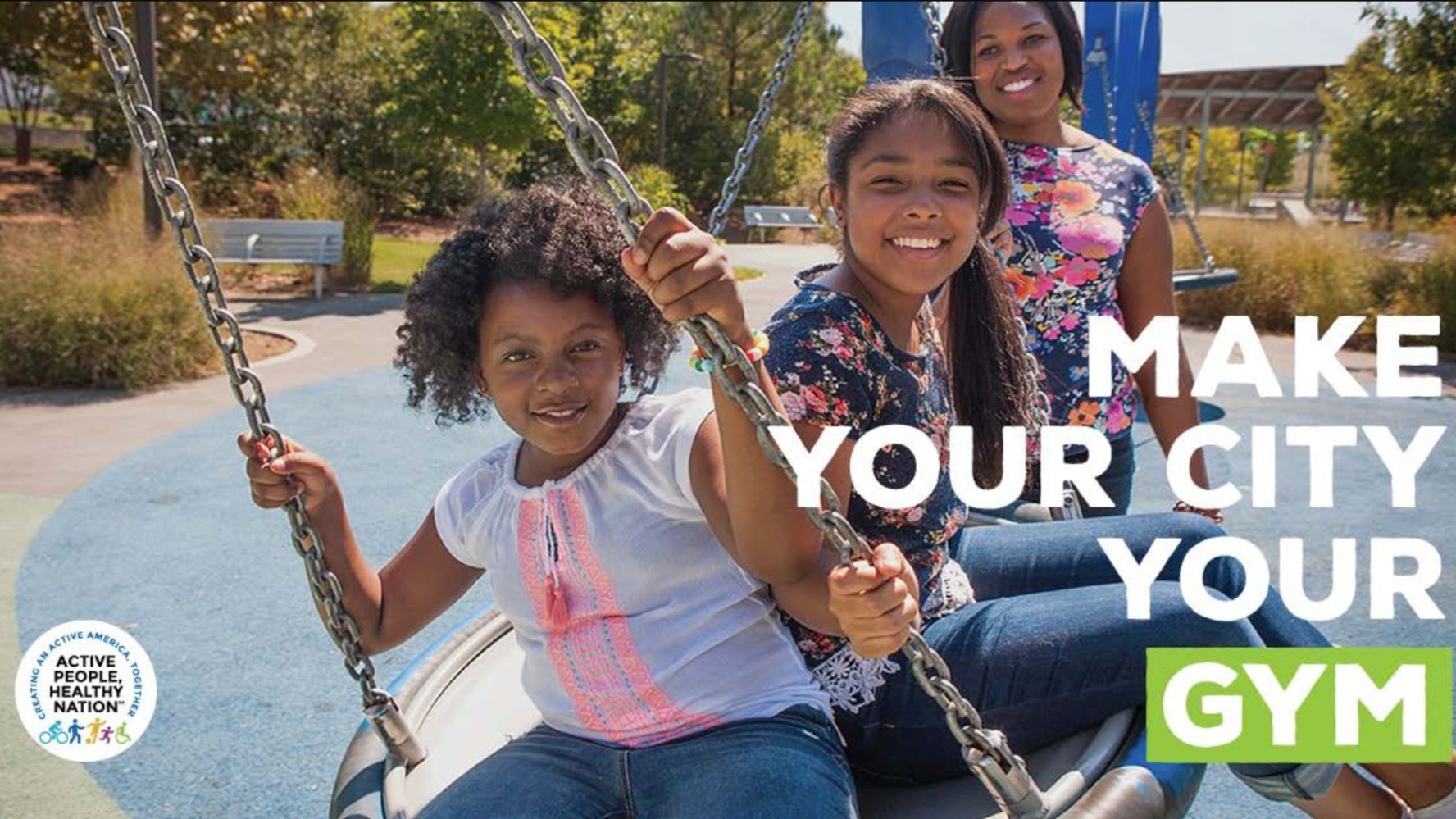 — title missing — Ad with girls on a tire swing saying "Make your city your gym"