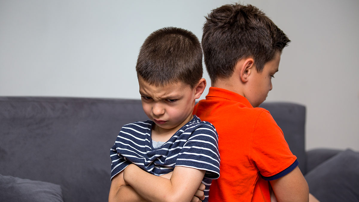 Two frustrated boys sitting back-to-back Two frustrated boys sitting back-to-back.