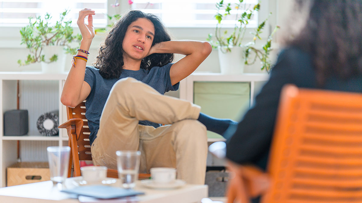 Young adult talking with doctor Young adult patient talking with therapist about ADHD symptoms.