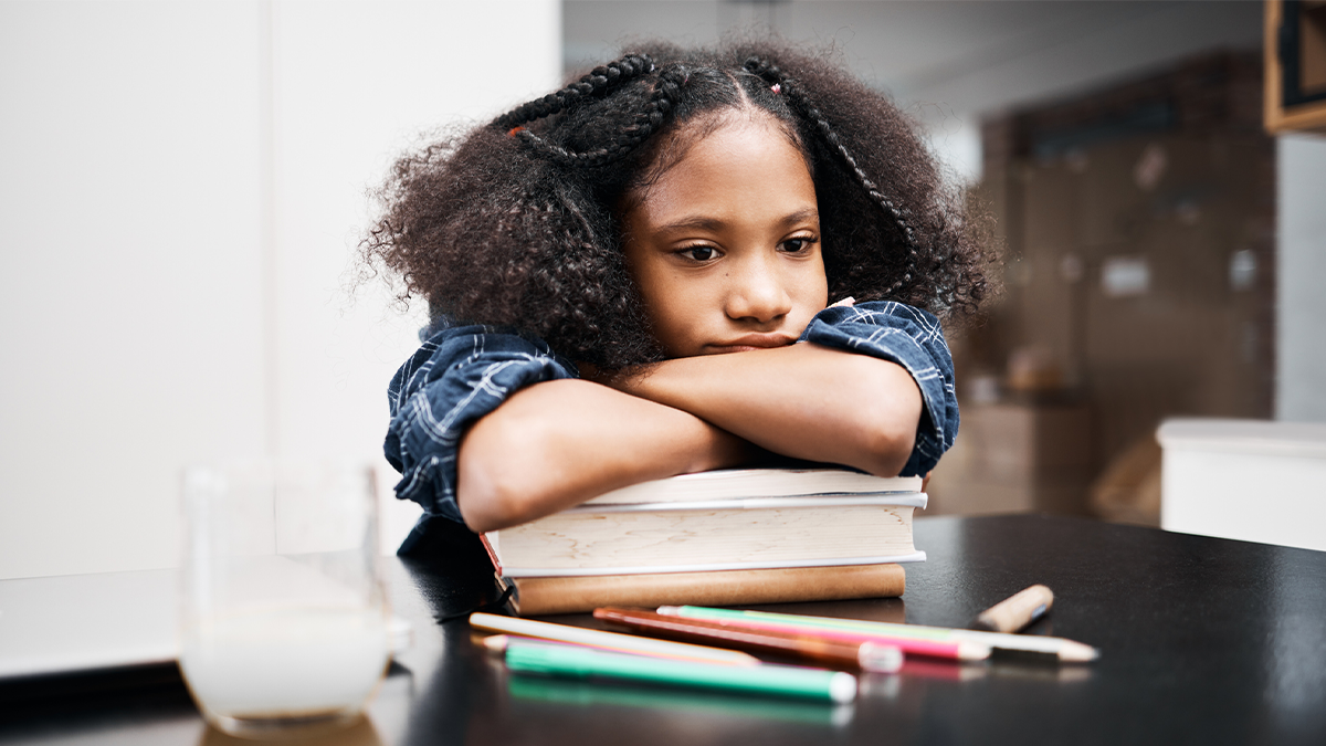 Learning disorders The child is putting her arms on top of her books, frustrated