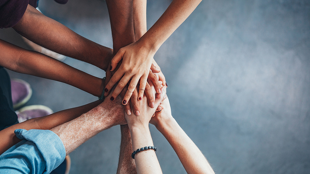 AlcoholHandsIn625736338.jpg Many hands join together in the center of a circle to demonstrate teamwork and collaboration.