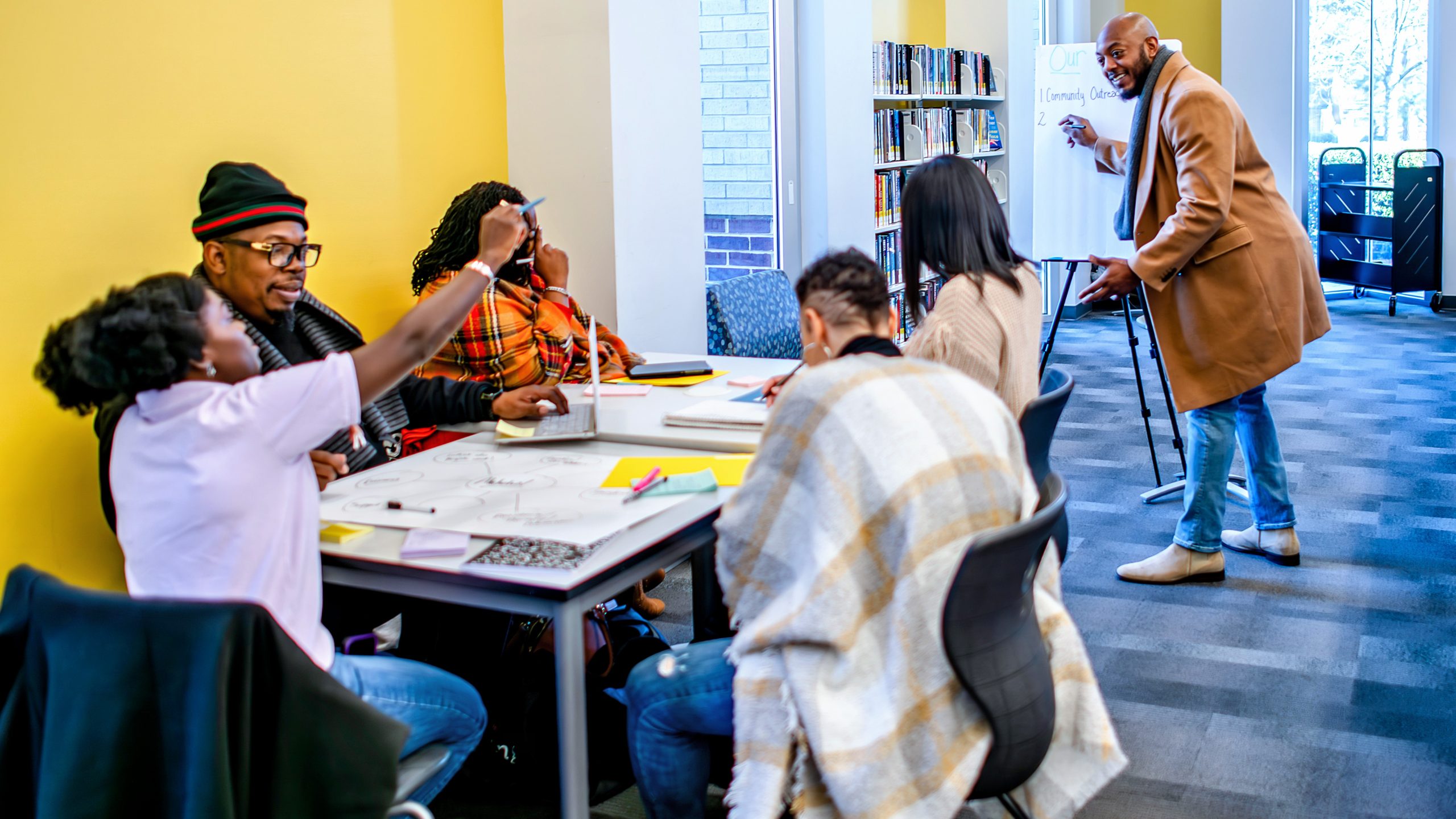 Community organizing library Community group is strategizing in a library.