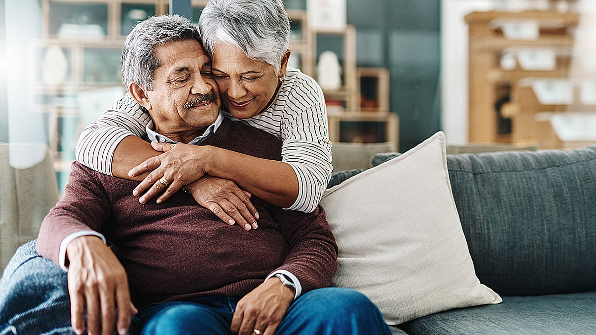Hispanic Couple Hugging on Couch Hispanic couple hugging on the couch.
