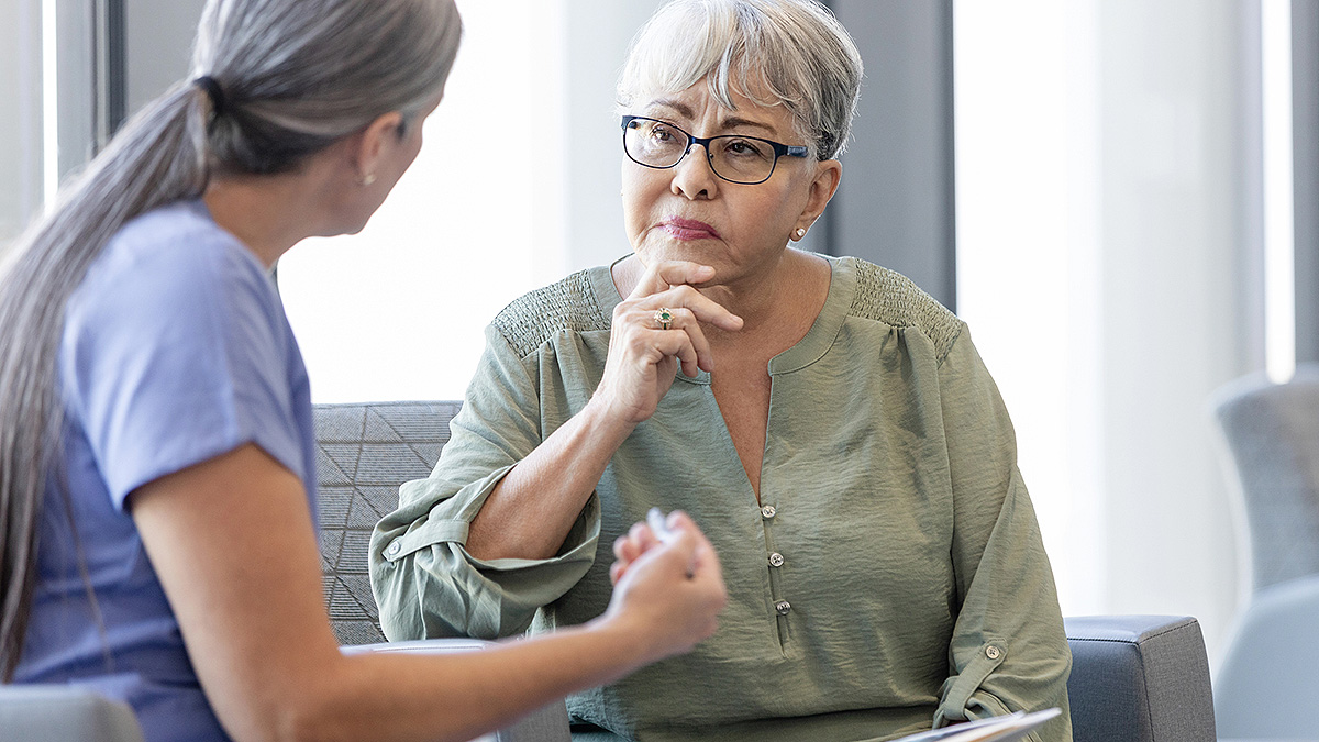 Female doctor explains recommendations to concerned female patient Female doctor explains recommendations to concerned female patient