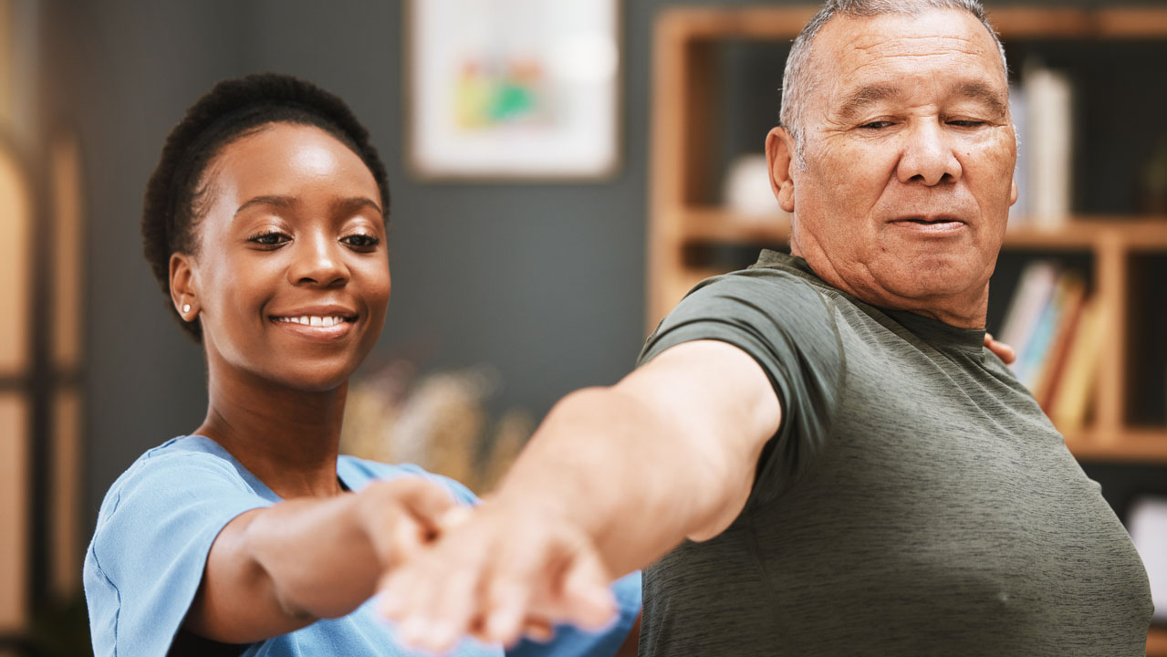 Patient stretching with physical therapist Man stretching with physical therapist.
