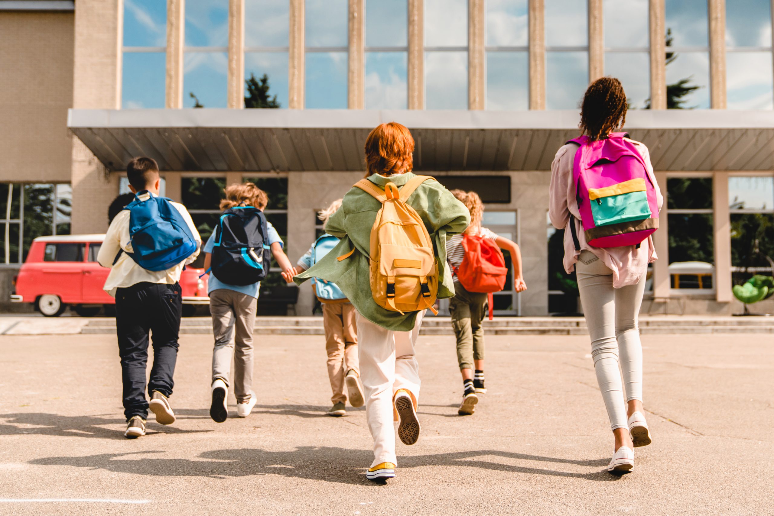 Students walking into a school. Students walking into a school.