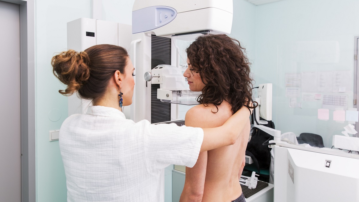 mammogram-b1200x675 a nurse positioning a woman for a mammogram