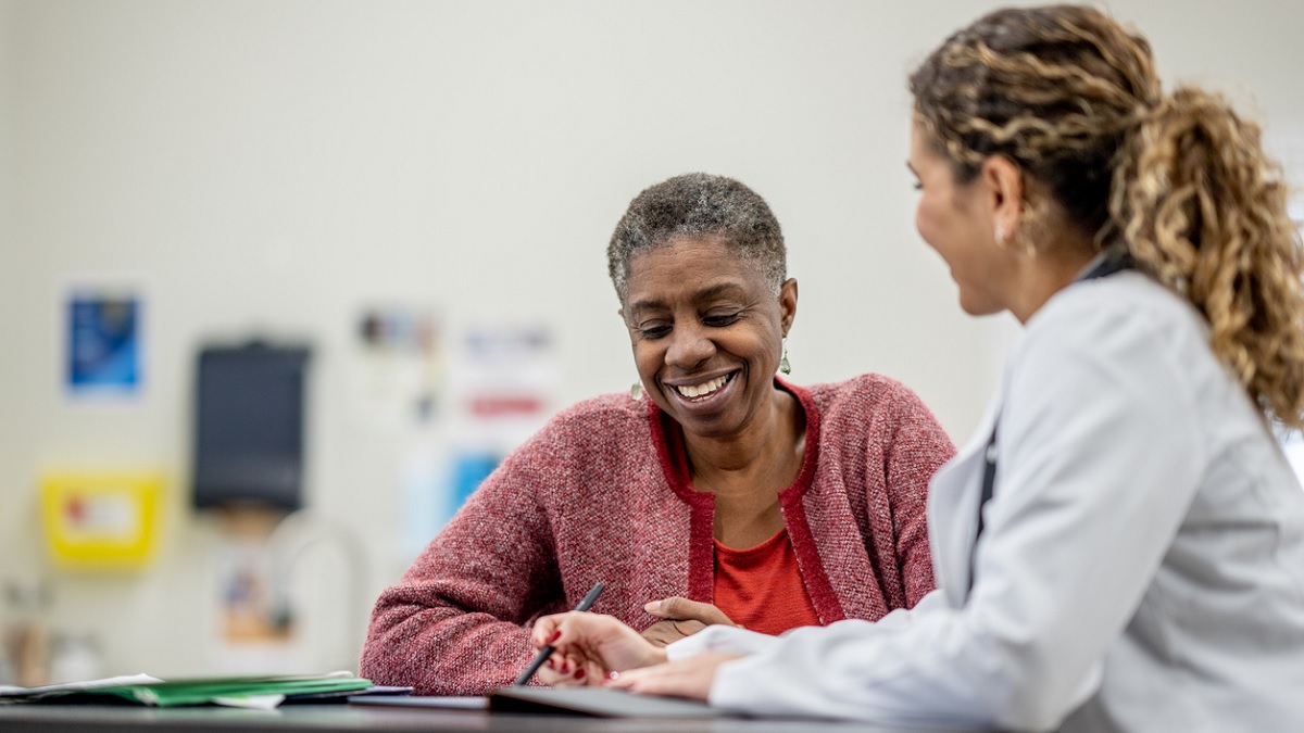 Woman with Doctor A senior woman talks to her doctor