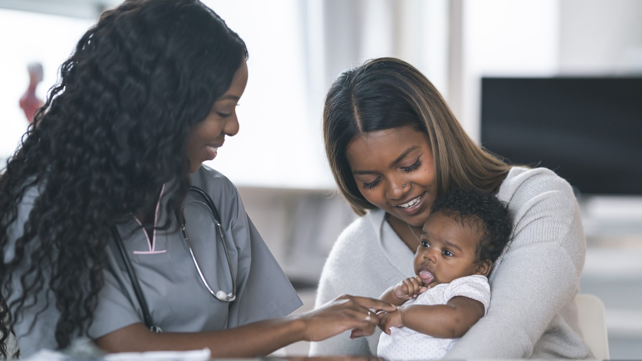 — title missing — Mom and baby talking to a doctor.