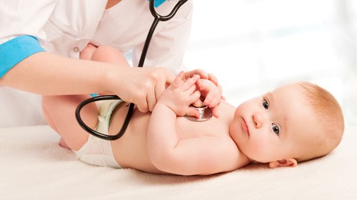 — title missing — Doctor examining baby.