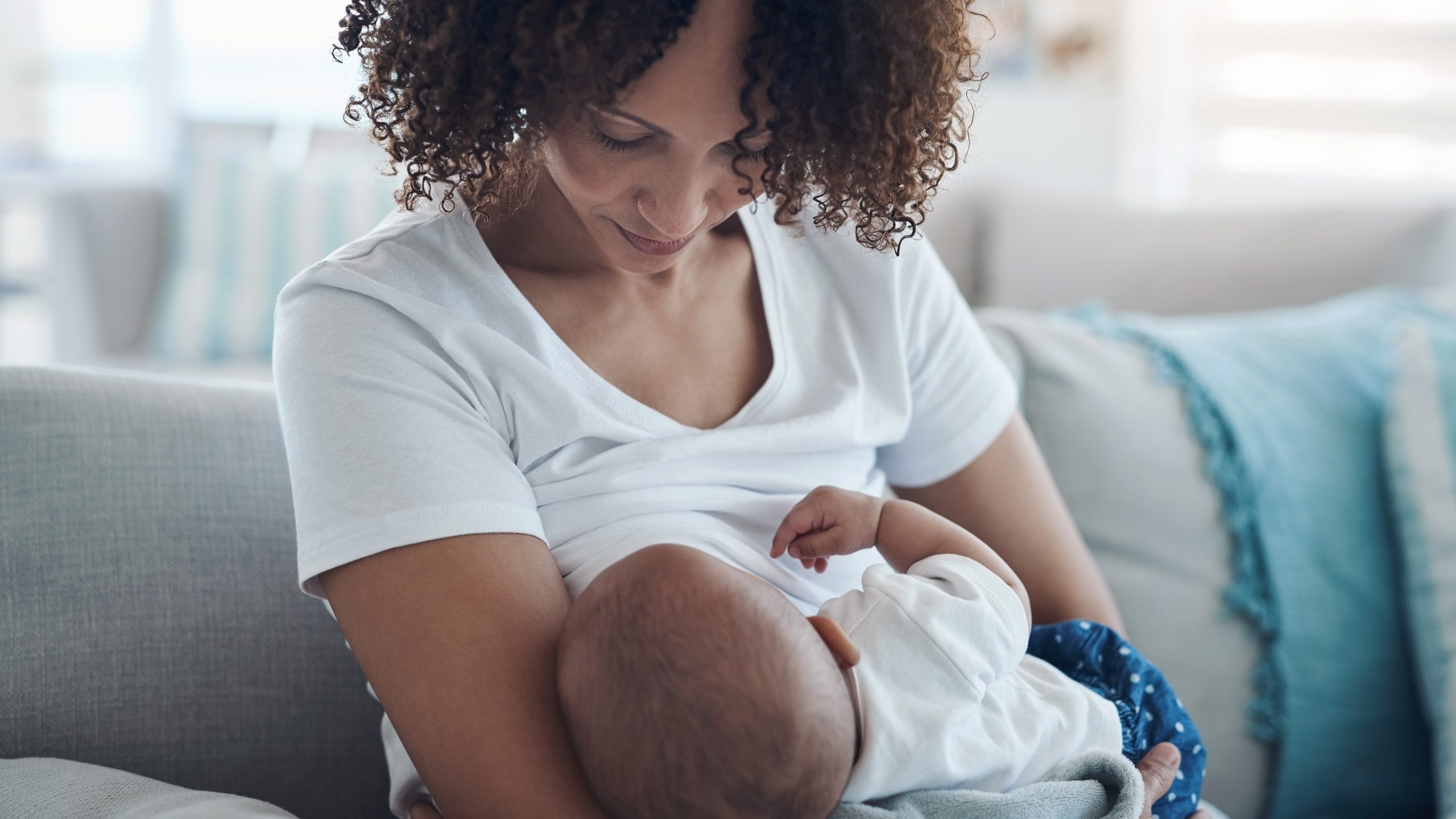 — title missing — Woman breastfeeding infant.