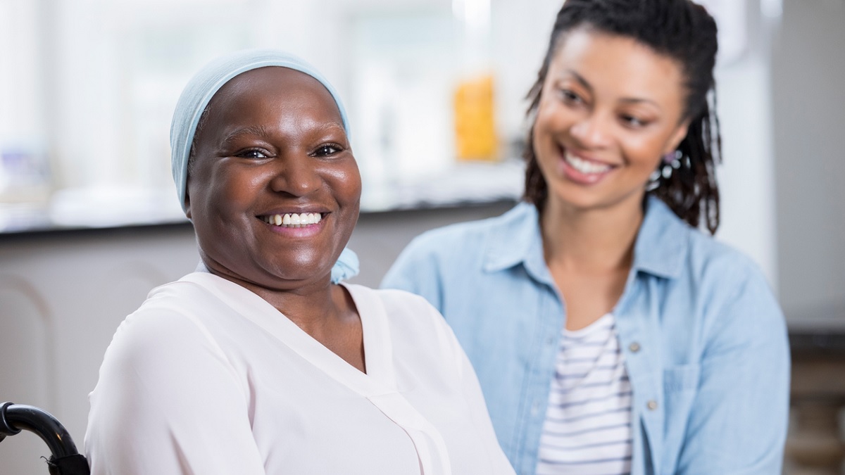 patient-daughter1200x675 An older cancer patient smiles as her adult daughter looks on.