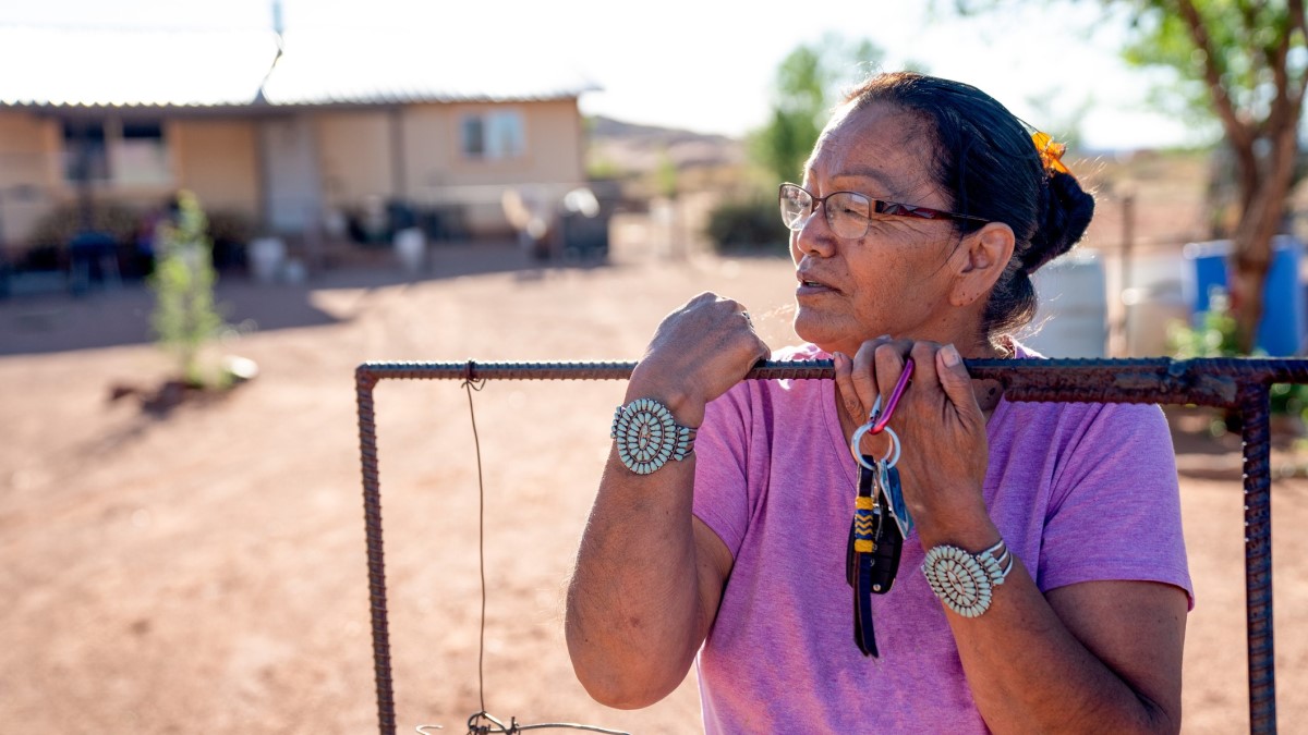 Navajo Grandmother A Navajo woman standing by the gate of her home in Monument Valley, Arizona