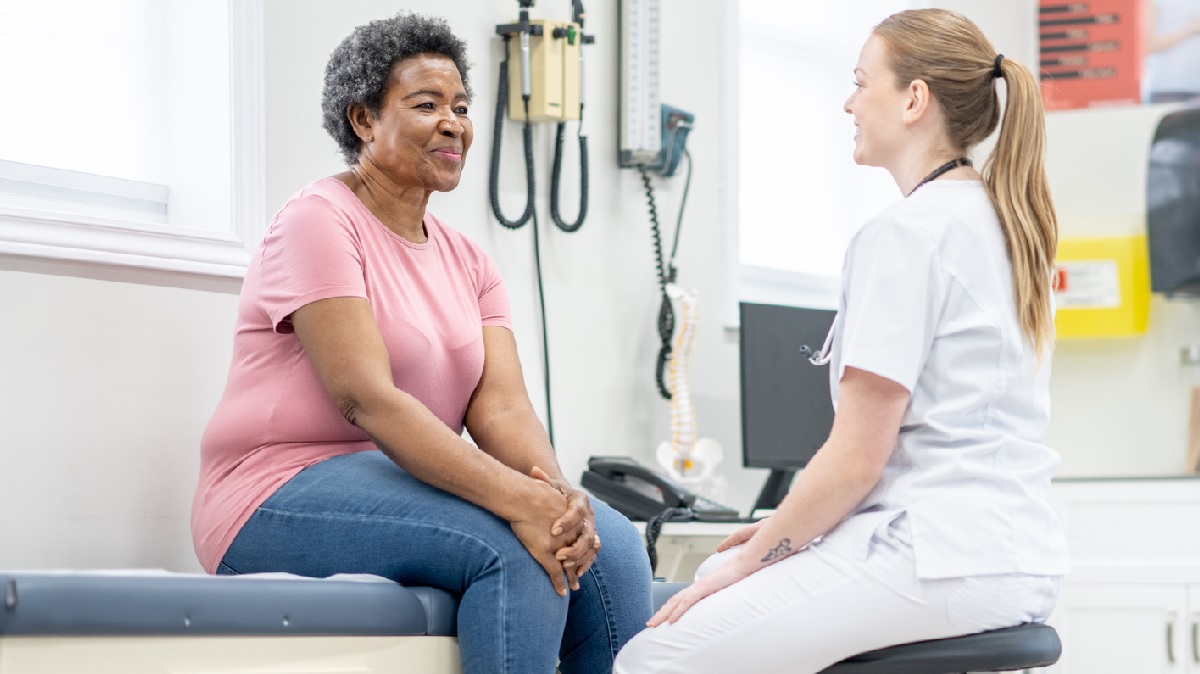 woman with doctor A doctor talking to a woman patient