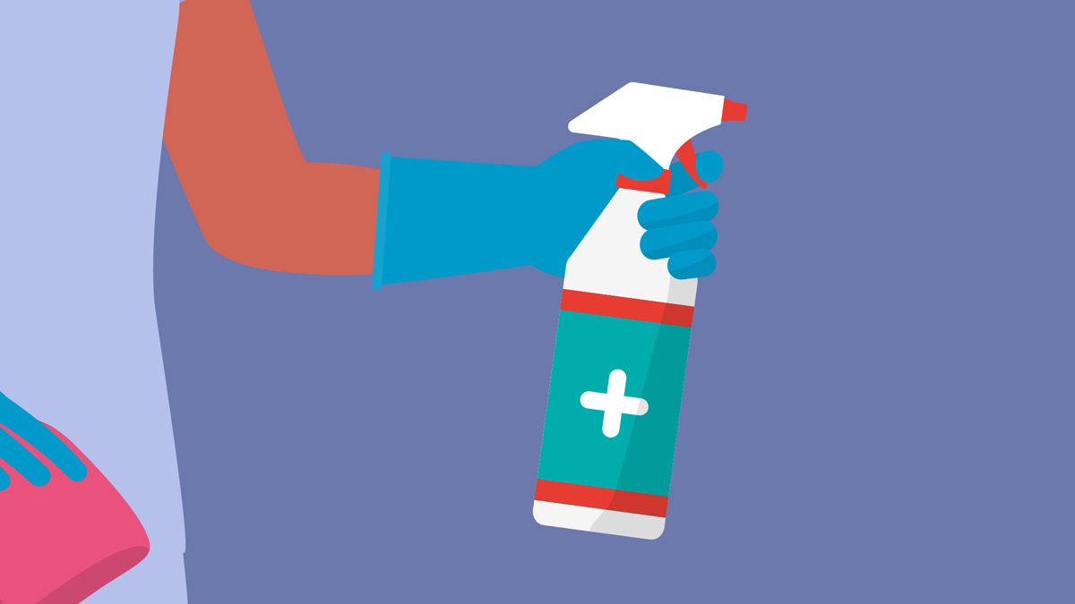 A hospital worker holding a bottle of cleaning product.
