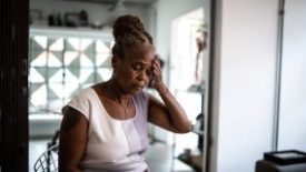 Older woman appearing stressed Older woman with hand on head appearing stressed