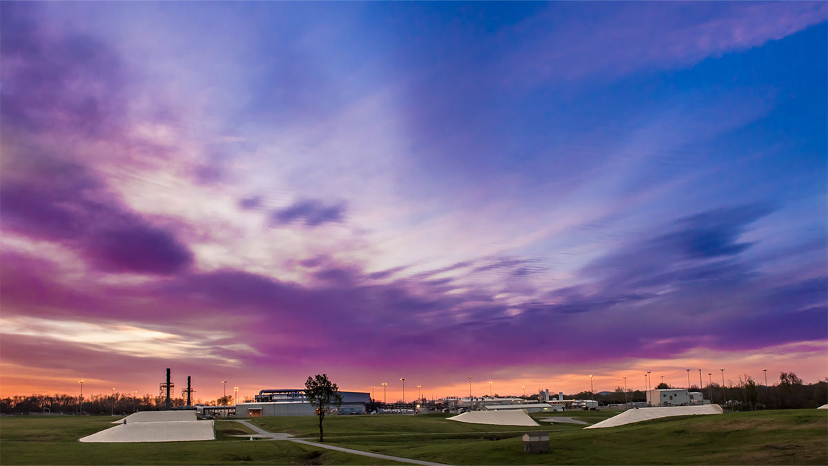 Stretch view of BGCAPP at sunrise A photo of an industrial facility at twilight.