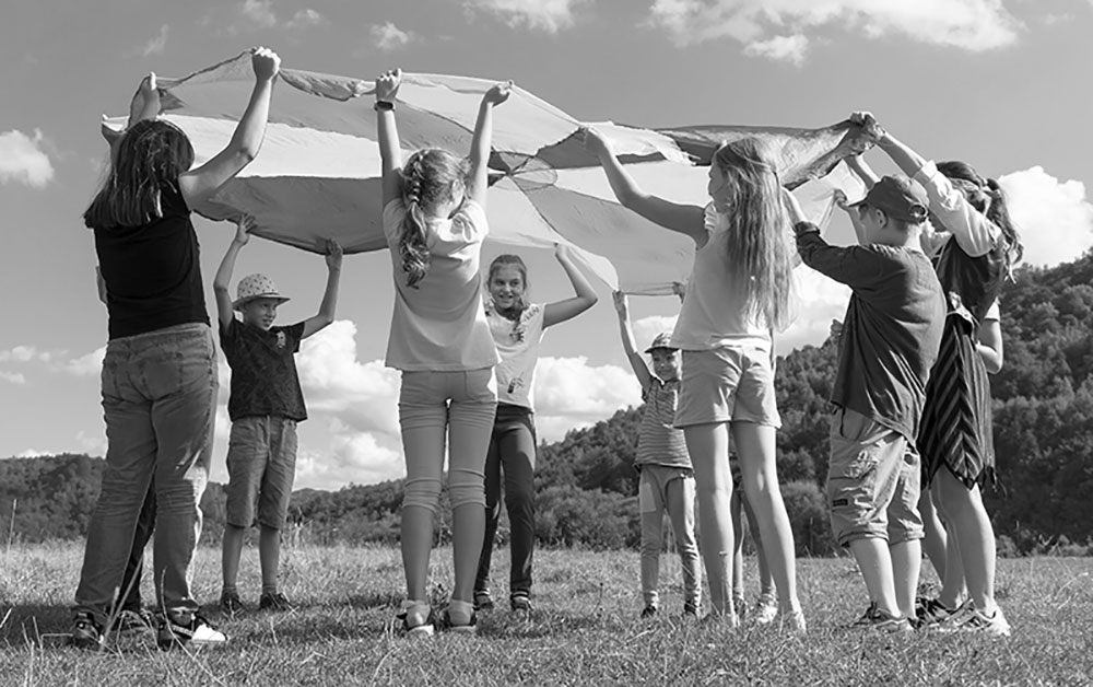 children-playing-parachute Children playing with a parachute.
