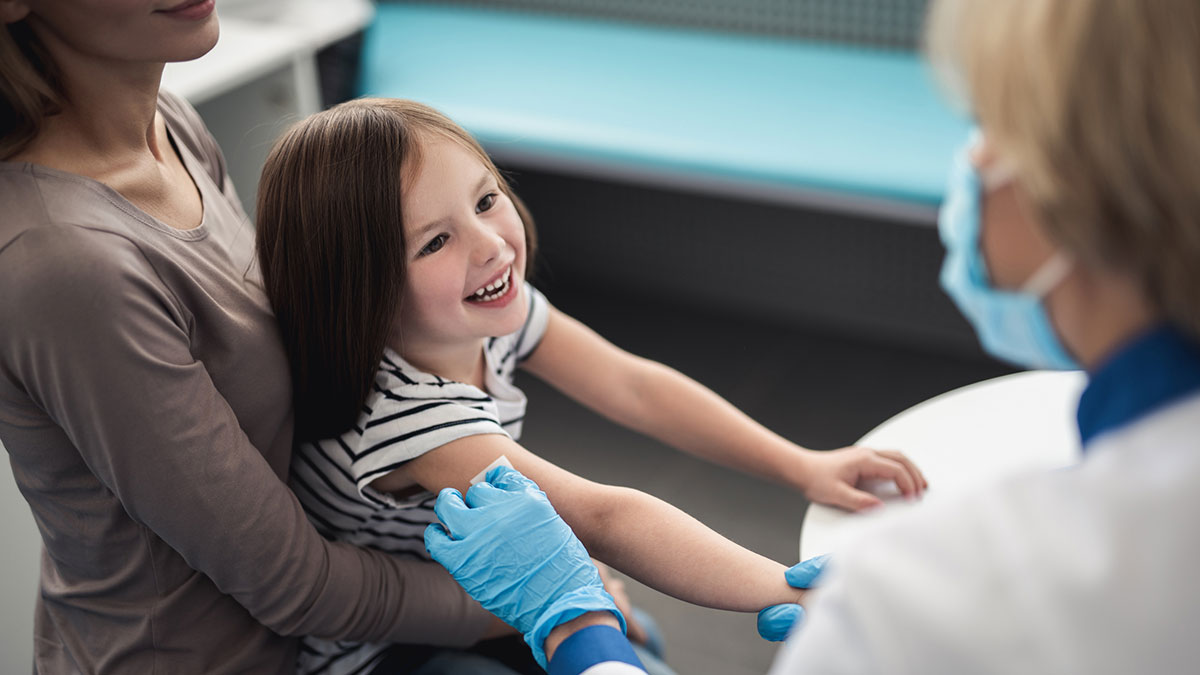 child smiling with doctor Vaccinated child smiling with doctor