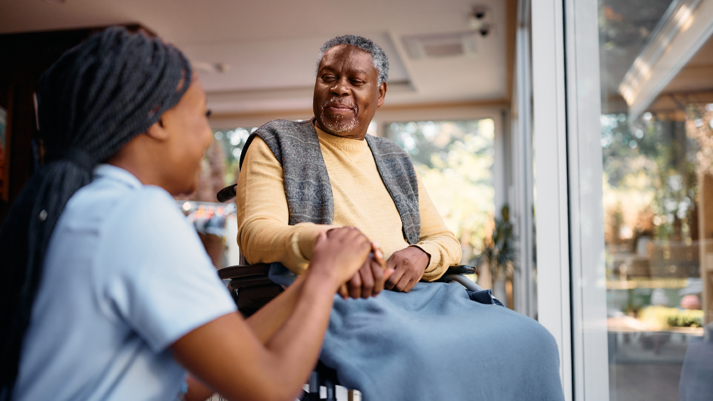 — title missing — Community health worker with a client in his home