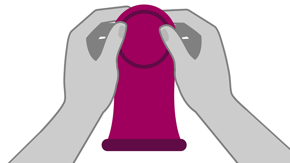Hands holding a female (internal) condom.