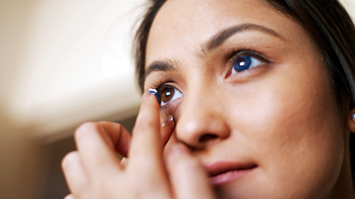 Decorative contacts Woman putting on colored contacts