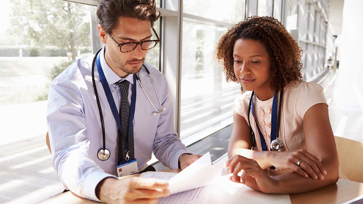 About PCNASP Two medical professionals reviewing some test results.