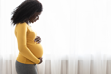 Pregnant women holding belly