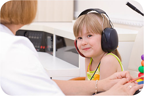— title missing — Young child receiving hearing checks from doctor.
