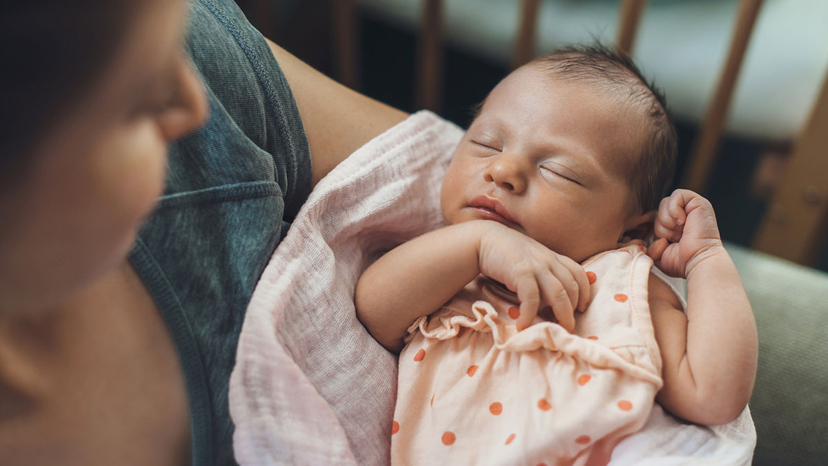 — title missing — Mother cradling newborn.