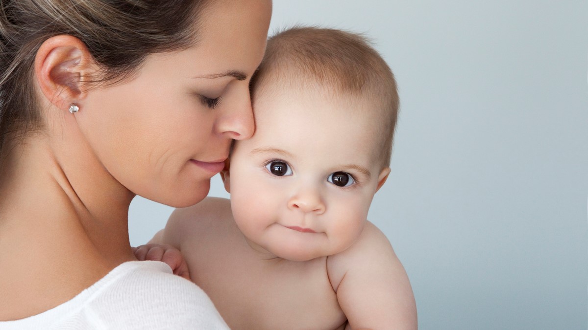 A mother holds her baby close to her face