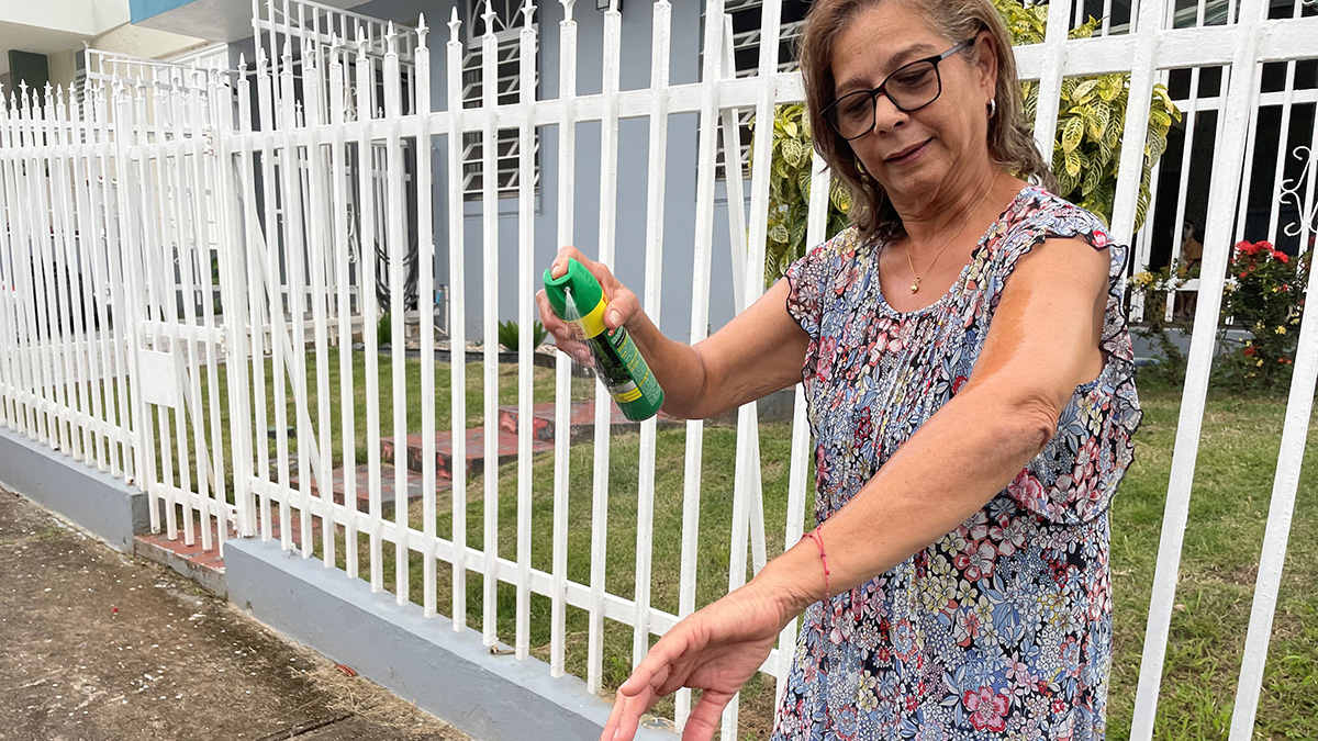 60plusMosquito Repellent Woman applying insect repellent