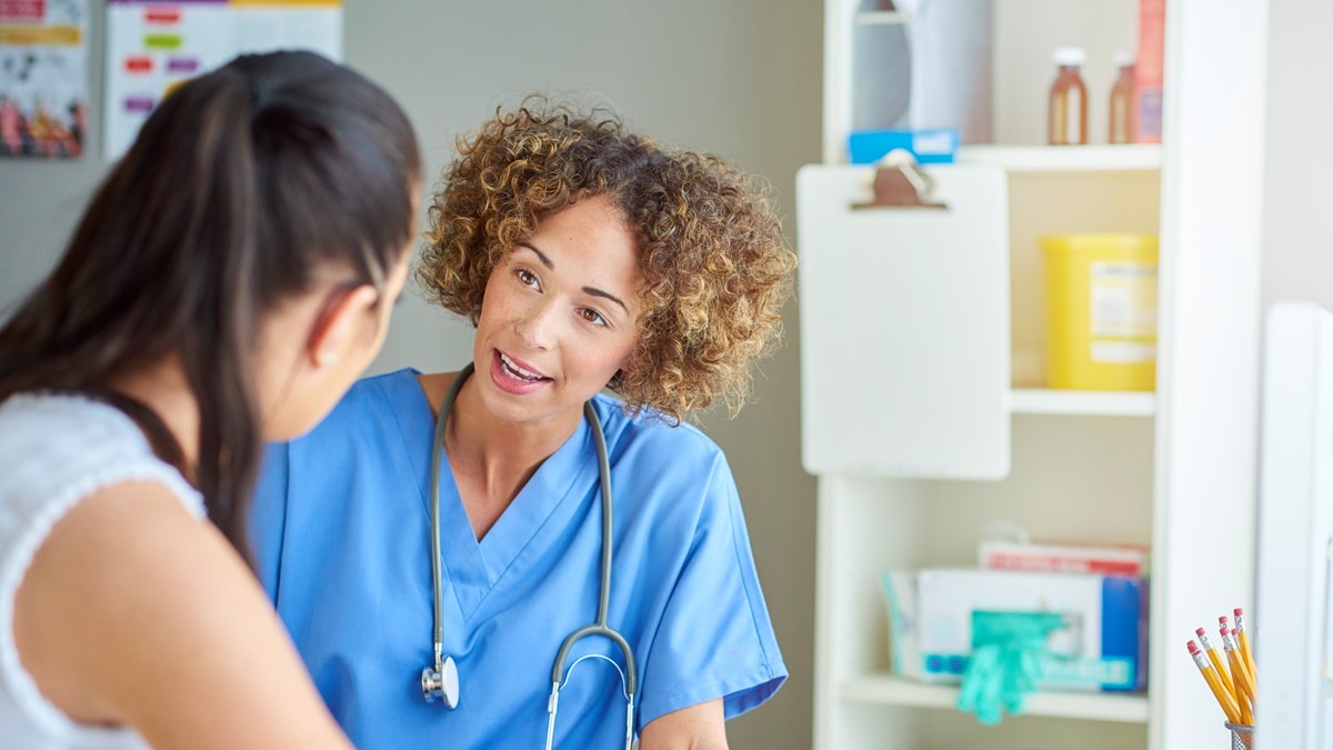 clinical care thumbnail A healthcare provider speaking to a patient in an exam room.