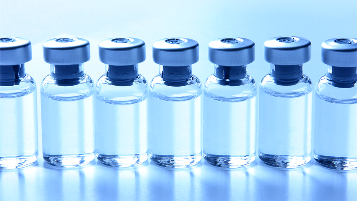 schedule and dosing thumbnail A line of vials containing clear liquid on a blue background.
