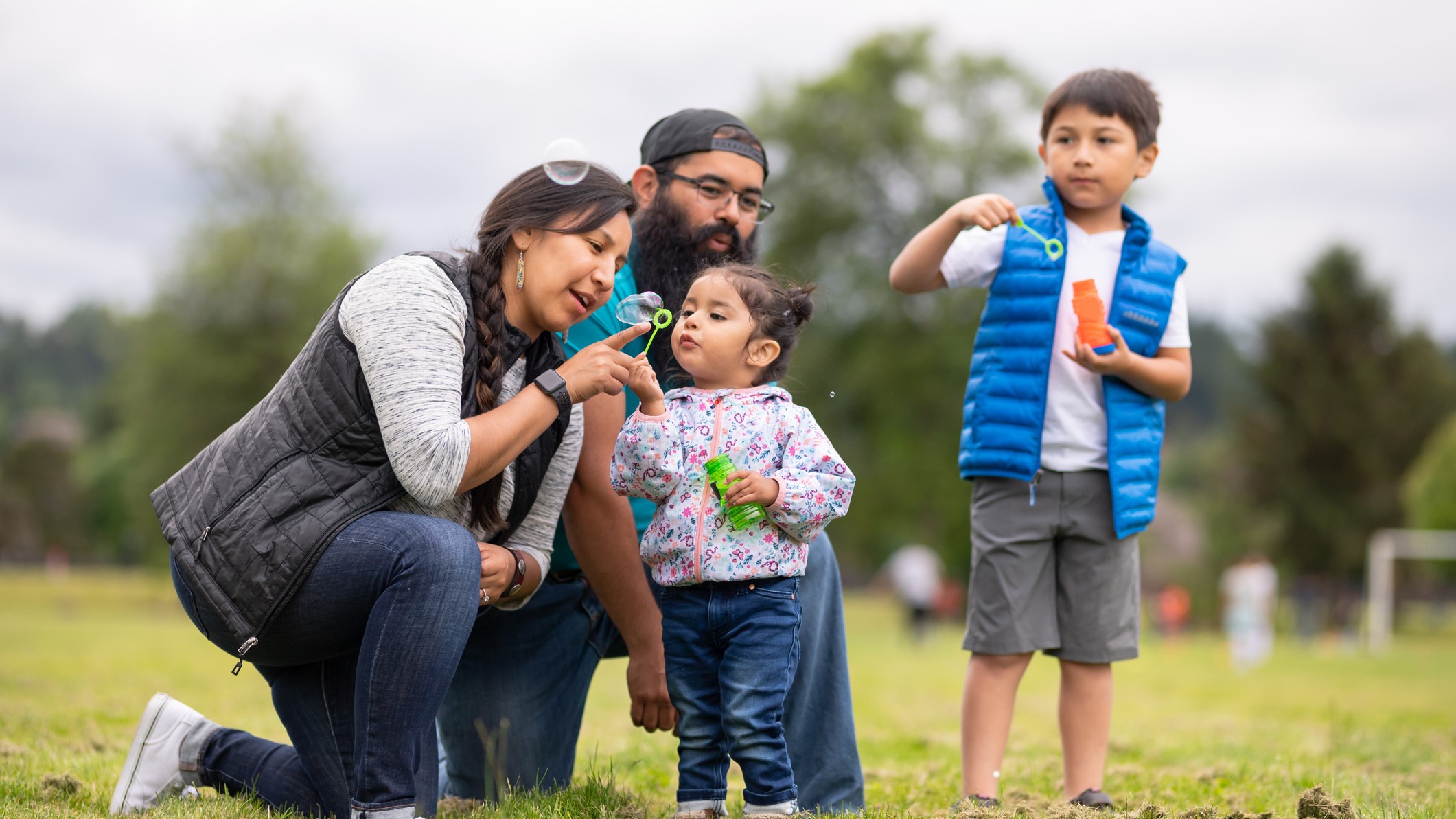 About NDWP Native American family blowing bubbles at a park
