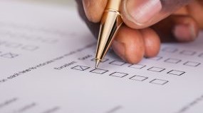 Quality measures A form with blank check boxes and a hand with a pen filling in the boxes.