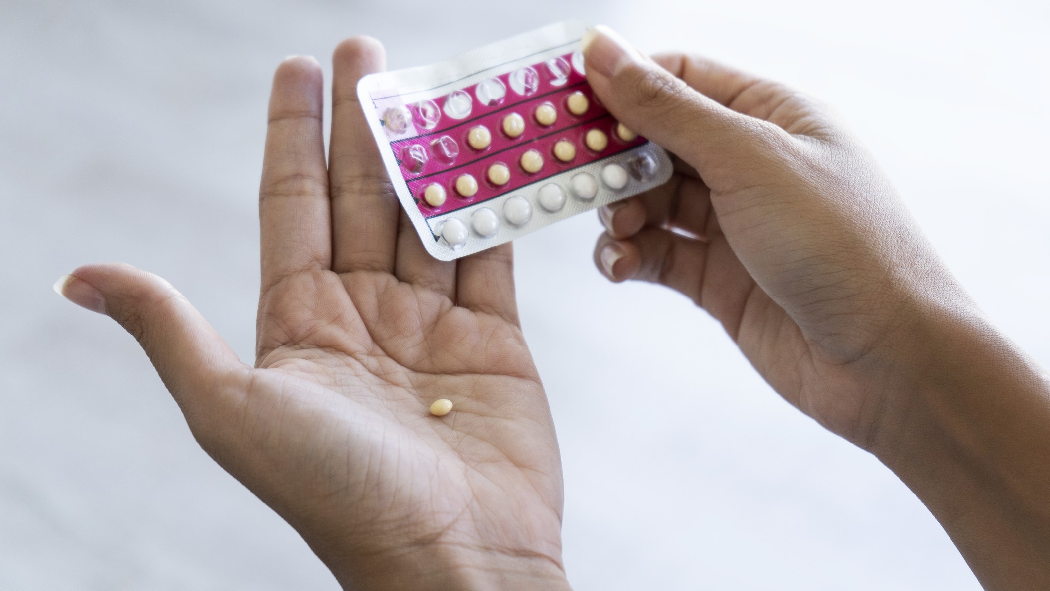 Diabetes and Hormonal Birth Control Closeup of a person removing a pill from a pill pack.