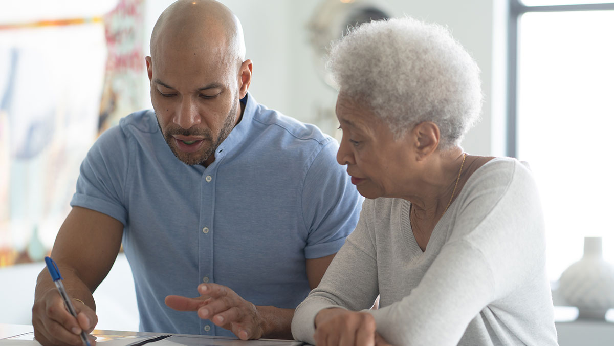 GettyImages-1184717555-cr younger african american man working with older african american women