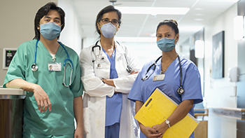 Healthcare providers Three healthcare providers wearing scrubs and masks