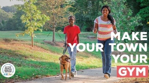— title missing — Mother and child walking dog in a park with the text "Make Your Town Your Gym" over the photo.