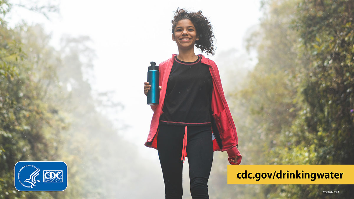 Hiker with water bottled graphic 1200x675 Smiling hiker carrying a reusable water bottle