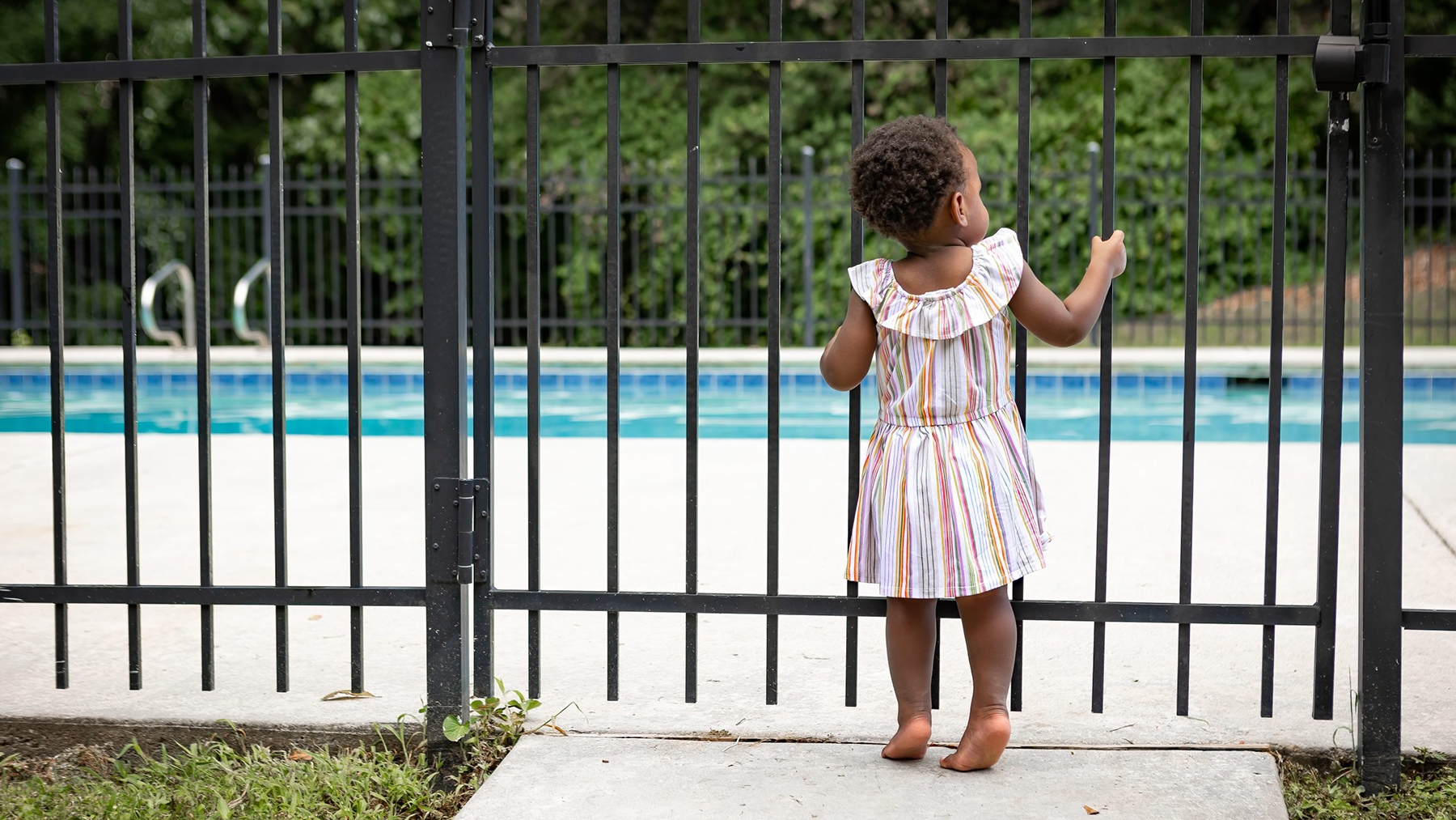 — title missing — Toddler at pool secure pool fence