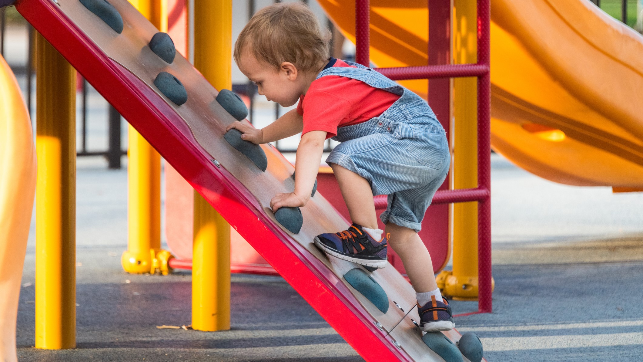 — title missing — Young boy climbing in playground