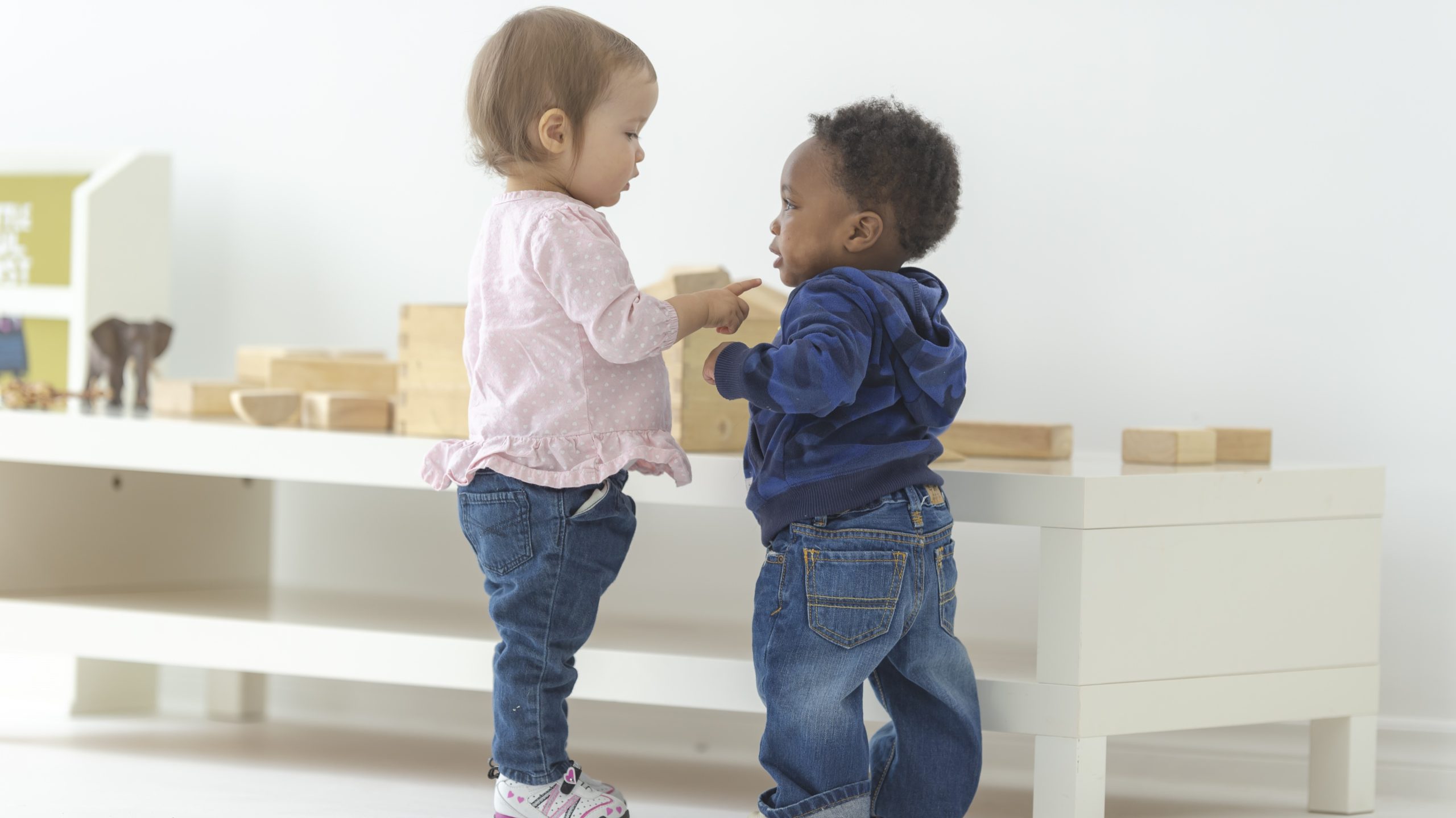 — title missing — Two toddlers talking in an early care and education classroom.