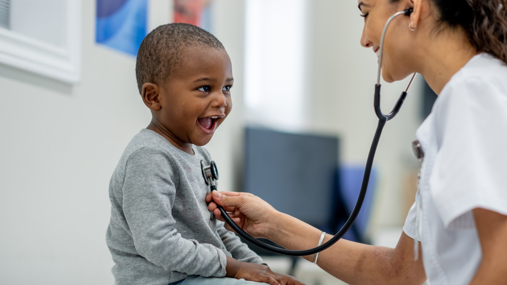 Young boy A doctor inspecting a young child with a stethoscope.