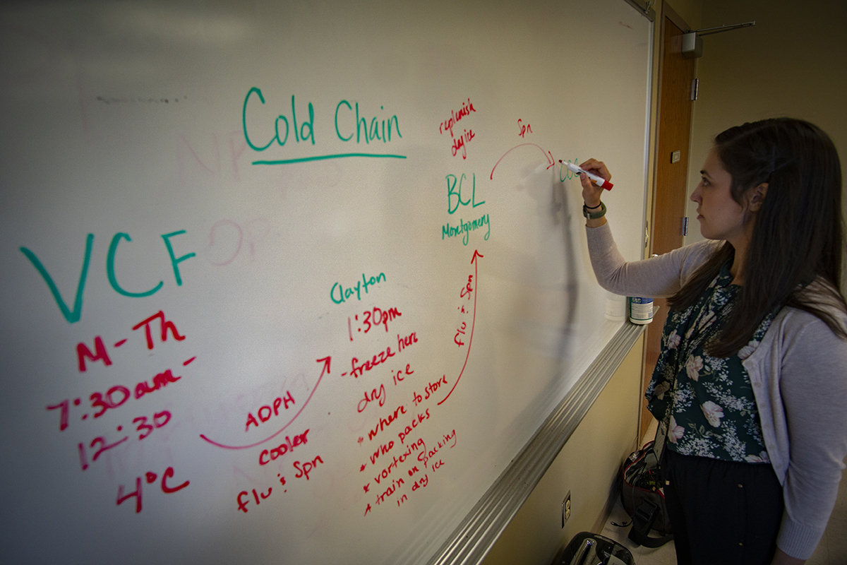 nicole-brown-epi-aid EIS officer writes notes on a whiteboard.