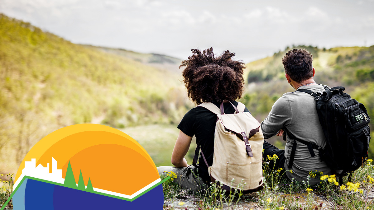 CDC Tracking Program Two seated backpackers overlooking mountainous horizon opposite CDC Tracking Program logo